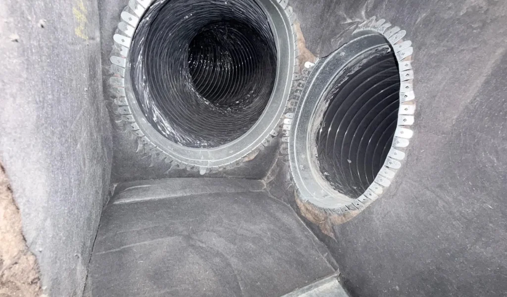 Freshly installed air duct take-offs banded into the plenum