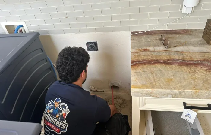 Air Busters technician cleaning a home air duct in the Dallas-Fort Worth area