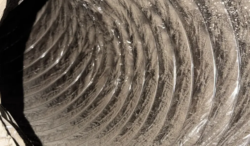 Freshly cleaned flexible air duct interior after professional cleaning in DFW
